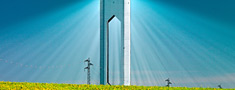 PS20 plant of the Solúcar Platform surrounded by the countryside in springtime and with blue sky in the background.